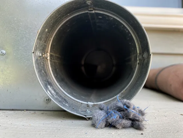 Pembroke Dryer Vent Cleaning technician using specialized equipment to clear severe dryer vent blockage in Pembroke